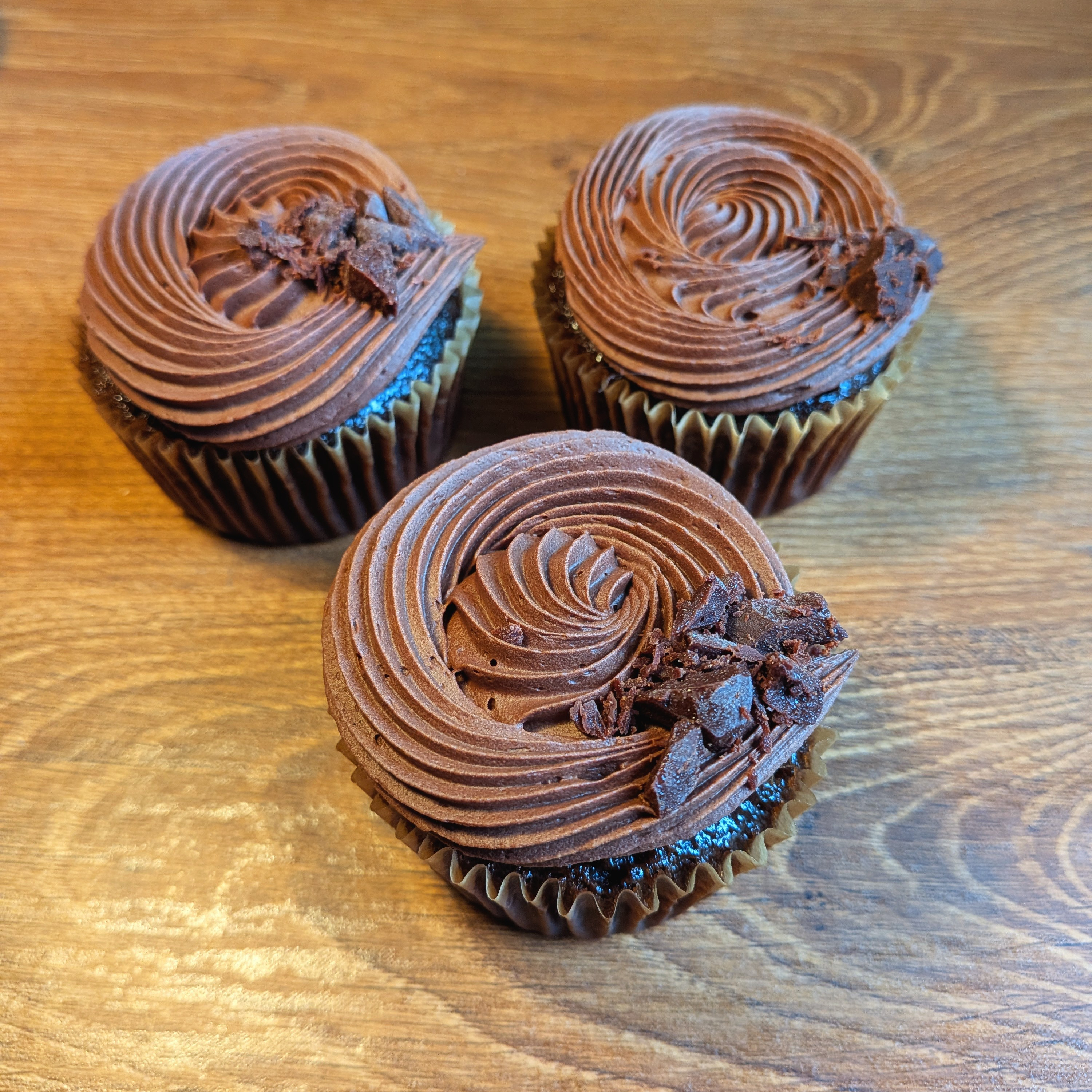 Picture of chocolate cupcake on windowsil from side