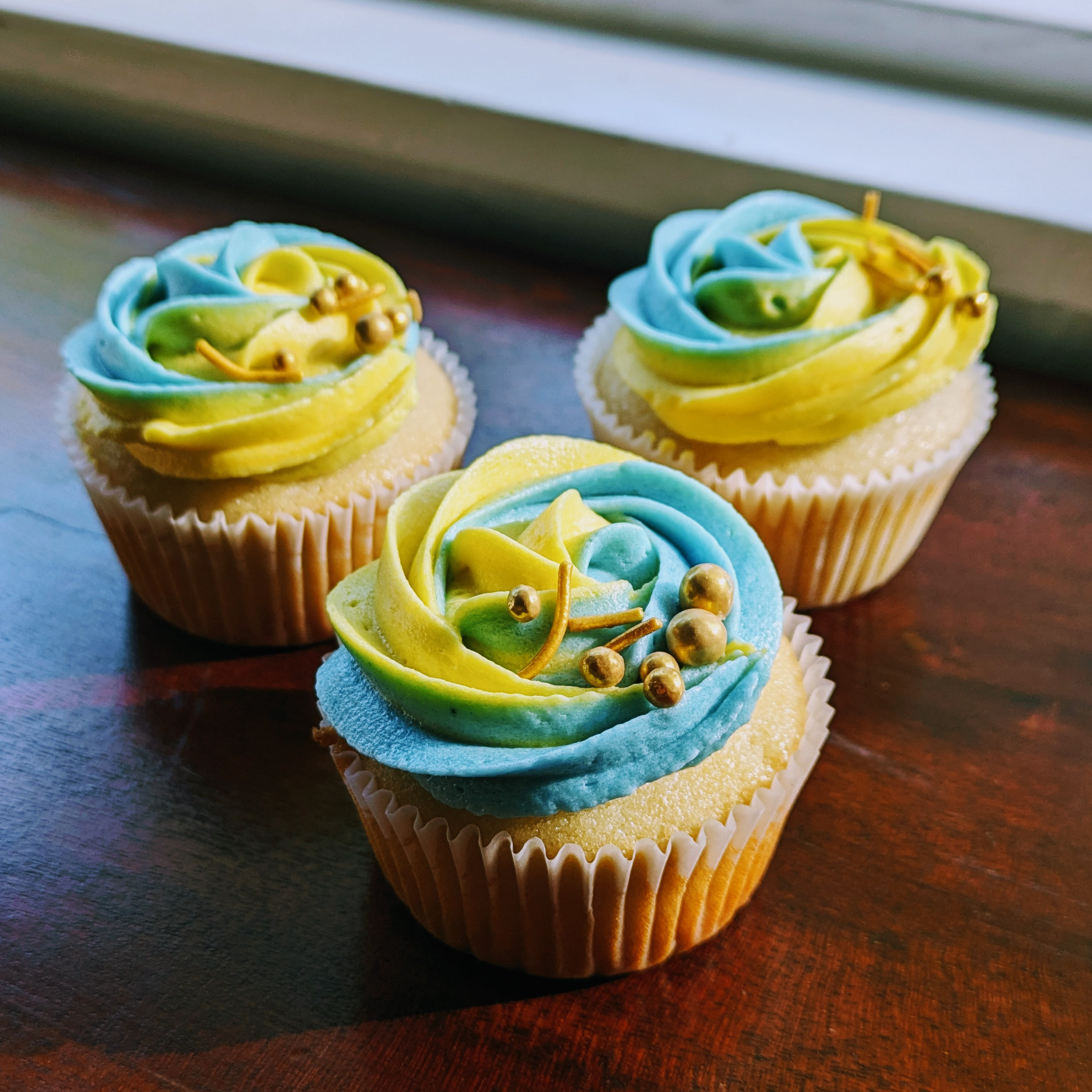 Picture of ukraine colored vanilla cupcake on table from side